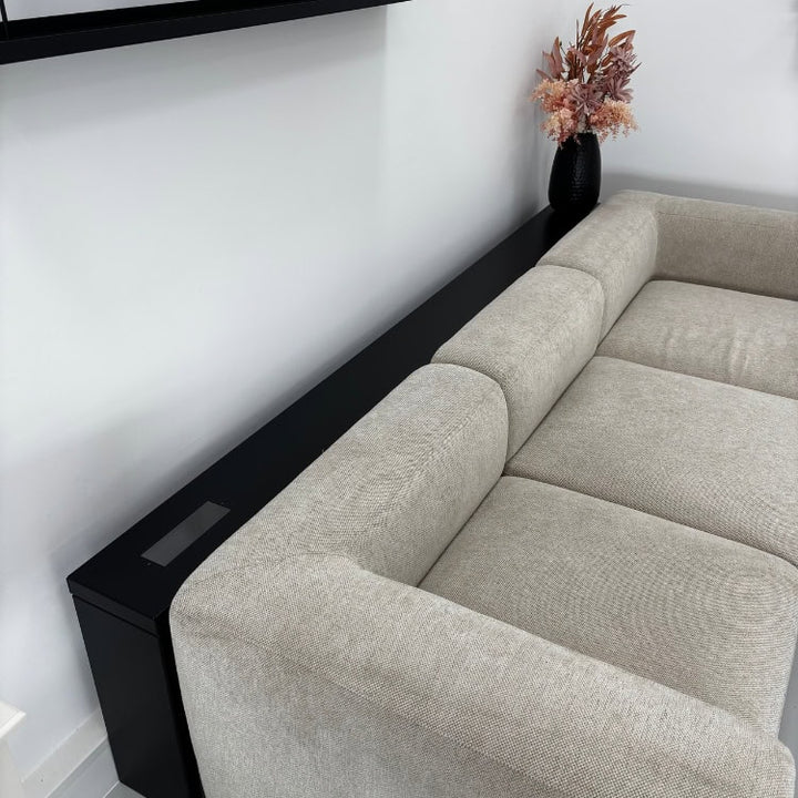 Zwarte metalen bijzettafel op maat naast een bank geplaatst, strak en minimalistisch